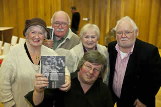 Marie Redmond, Sean redmond, Irene Redmond & Fergus Redmond who appeared as children in the cover photo taken in the 1940's. Chris Reid is holding the book.