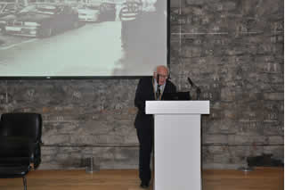 John Gallagher delivered the opening speech at the foot of the old city walls. Photos from local peoples personal collections were projected on the large screen behind him. 