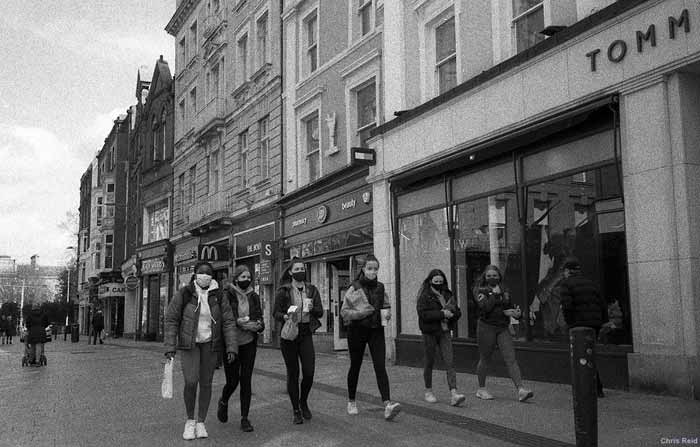 Fig. 19 A group of women wearing face masks walk up a deserted Grafton, January 2021.