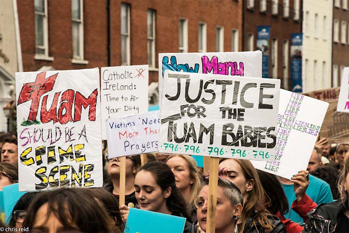 Fig.14 People carrying placards highlighting unresolved crimes walking on Parnell Square East.