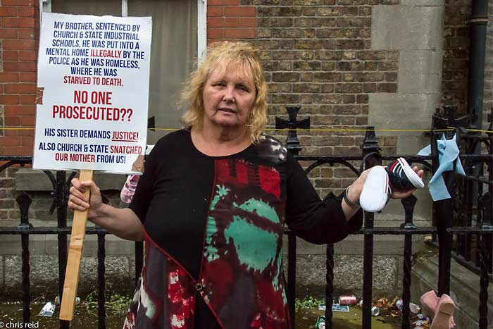 Fig.25 Mary Smith holding her banner and a pair of baby's boots outside the former convent and
Magdalene Laundry on Sean McDermott Street, Dublin.